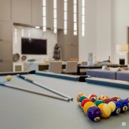 a pool table and a tv in the background