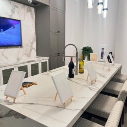 a kitchen with little art boards on easel and a tv