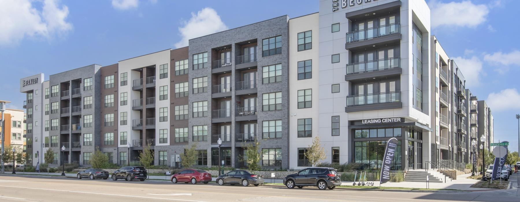 a large building with cars parked in front of it